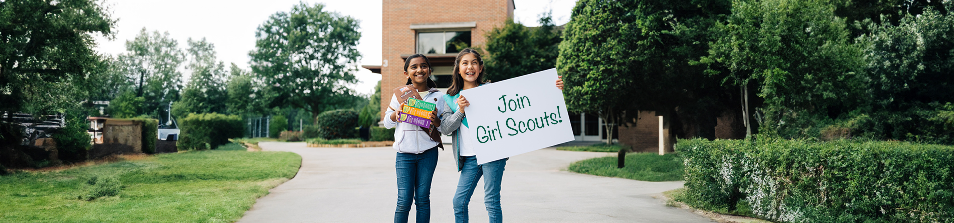  Group of Girl Scouts smiling at each other outdoors 